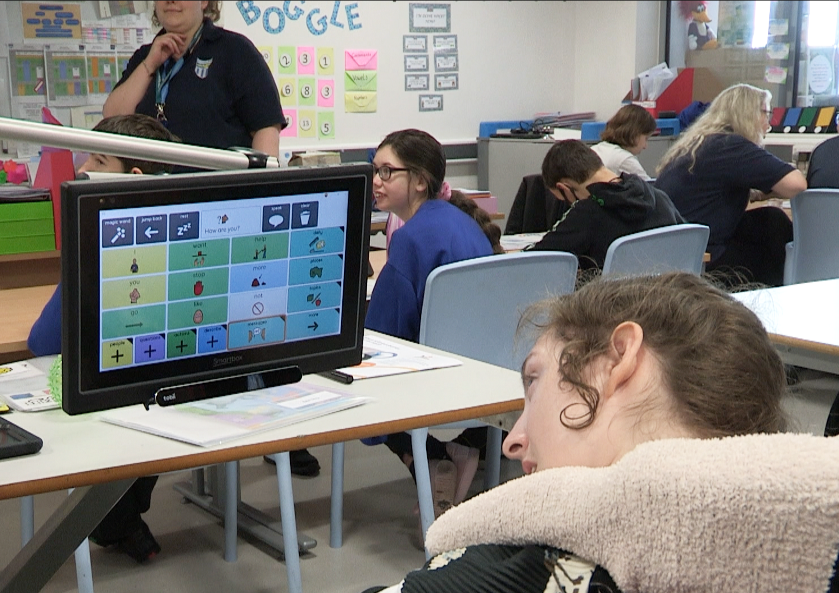 inclusion - a girl is learning in a classroom while using a screen reader